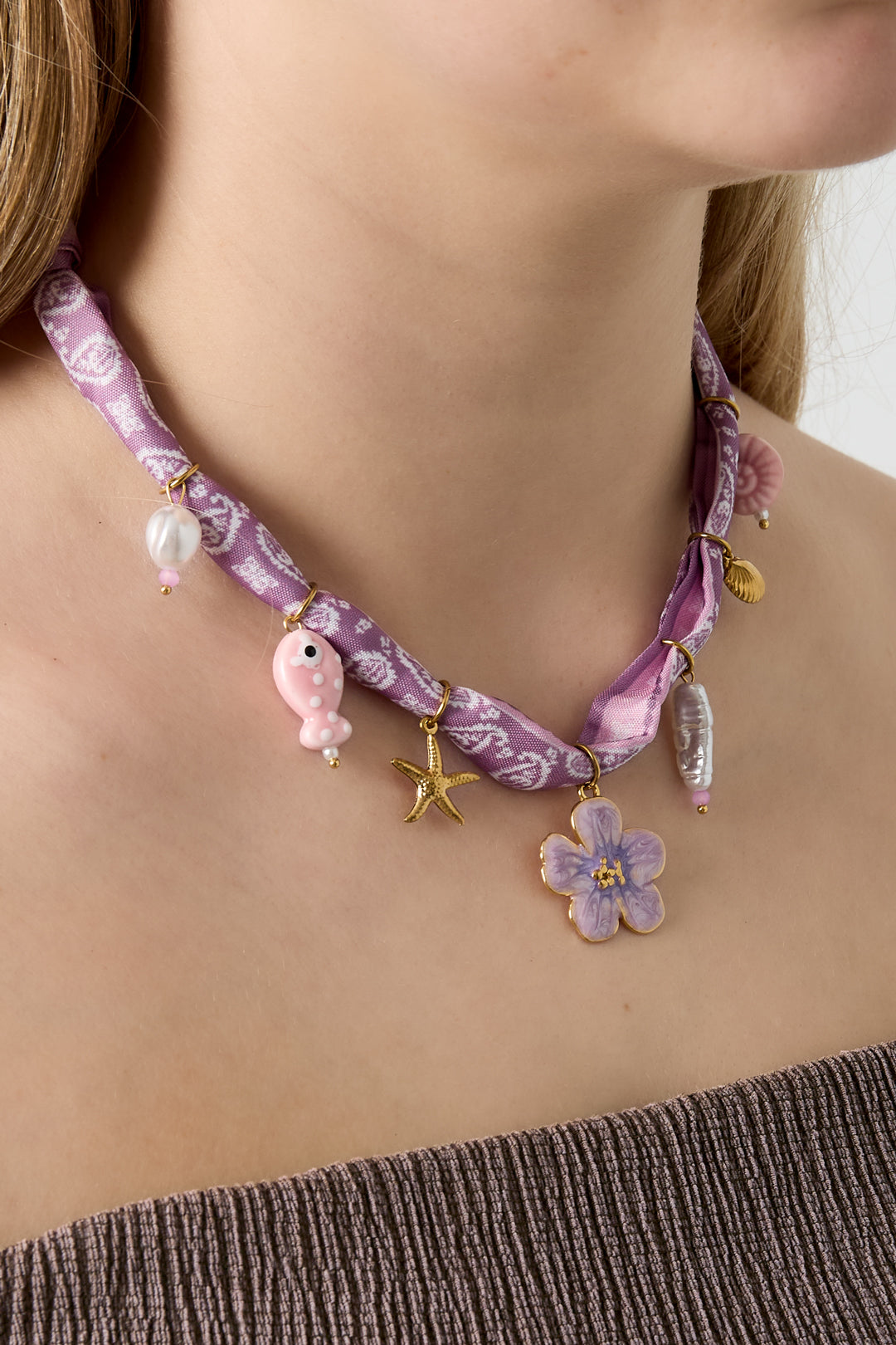 Playful charm necklace with flowers and shells